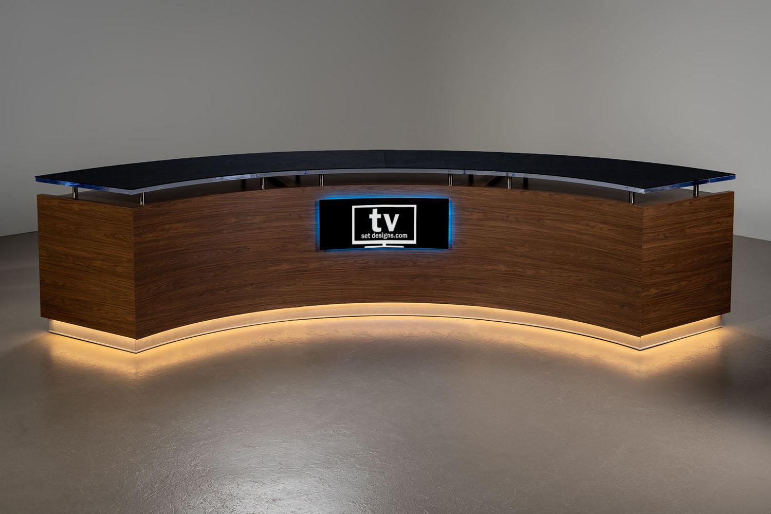 Custom modular Curve News Desk comprised of three Small Curve Desks with RGB underglow and graphic halo lighting